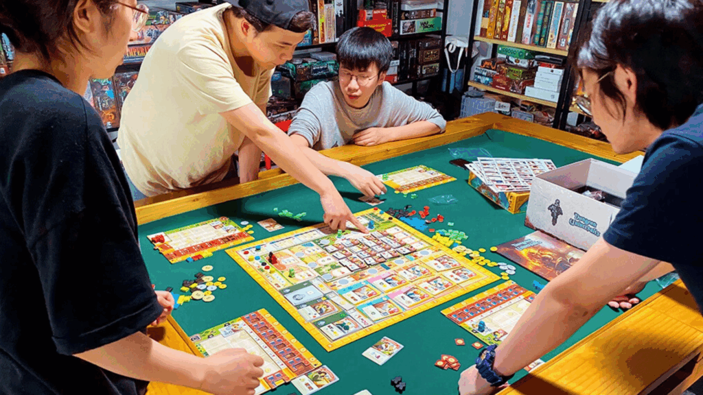 Group of playtesters around a table playing a prototype board game, giving real-time feedback on rules and components.