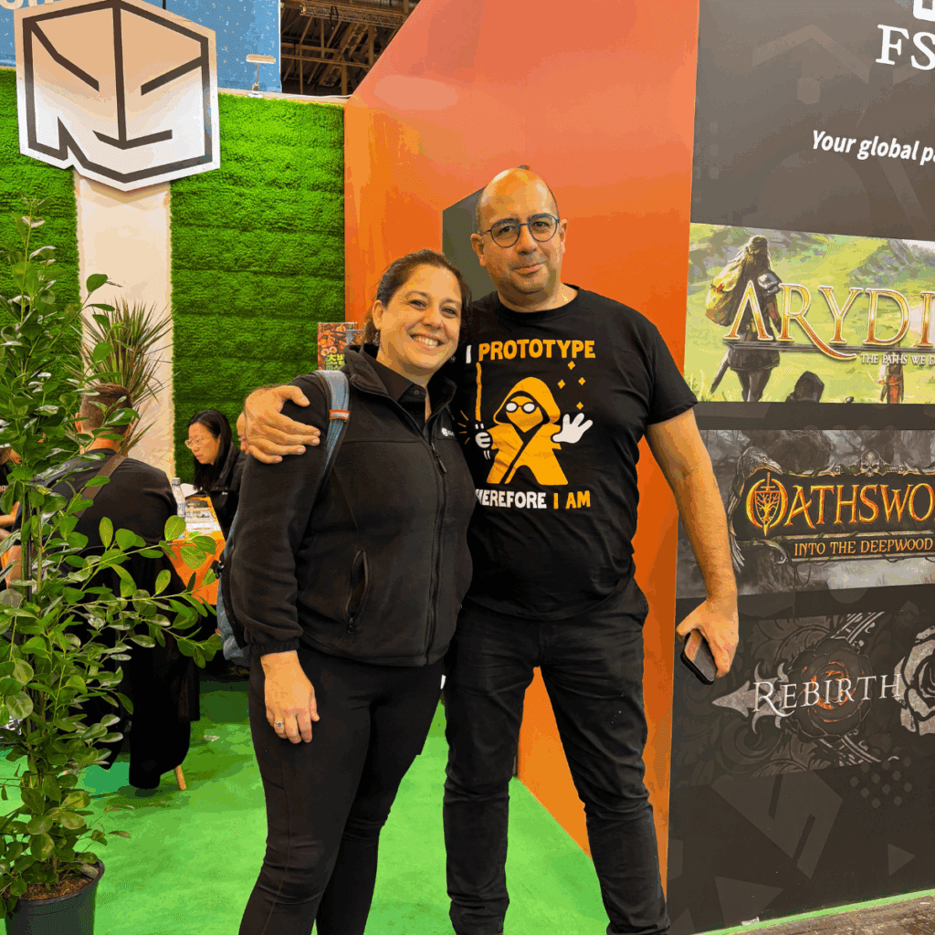 Rawstone Games team meeting with a client at SPIEL Essen 2025, discussing sustainable board game manufacturing and licensing opportunities.