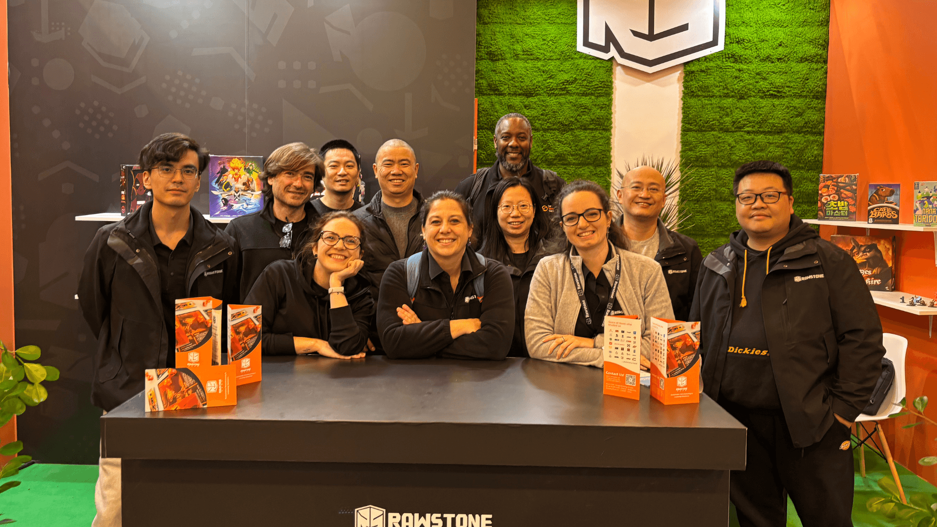 Rawstone Games booth at SPIEL Essen 2025 with visitors engaging in discussions about sustainable board game manufacturing and international licensing.